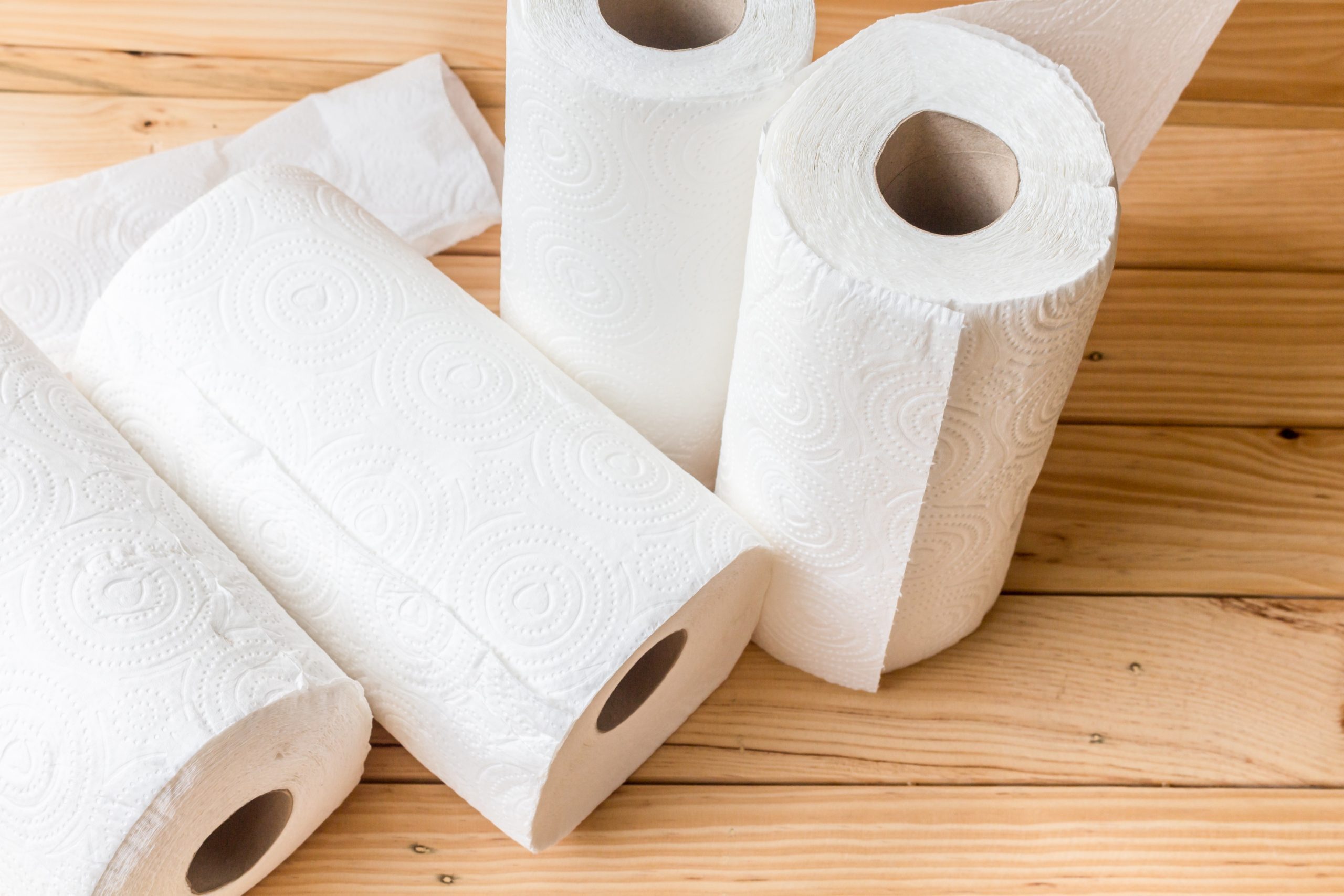 Roll of paper towel on wooden background