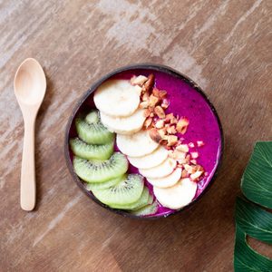 Smoothie bowl with fresh fruits,kiwi, banana and homemade granola almond for healthy vegan vegetarian diet breakfast.