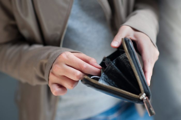 Little girl with wallet and her fingers