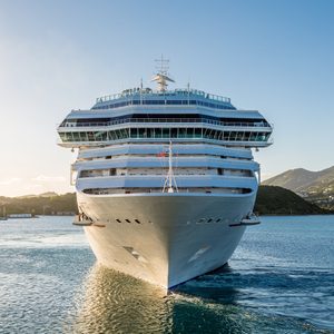 White Luxury cruise ship in bay from front