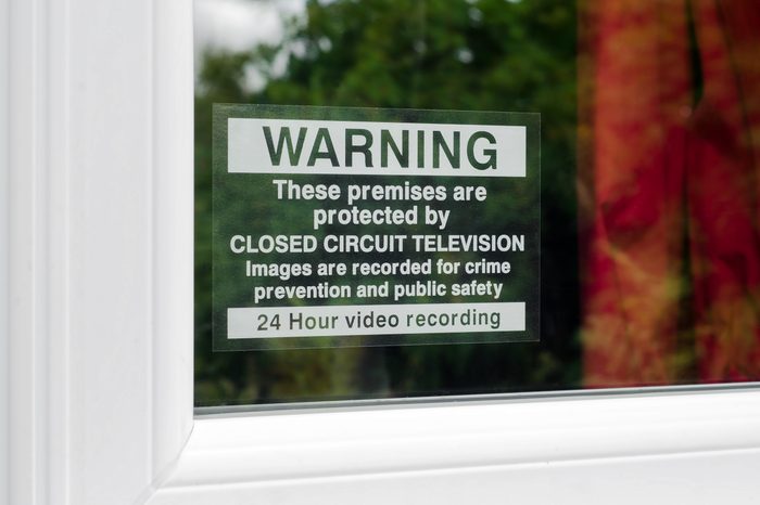 Warning these premises are protected by CCTV sign on the window of a protected property.