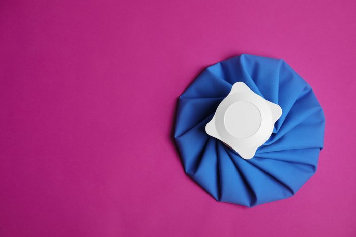 Ice pack on purple background, top view. Space for text