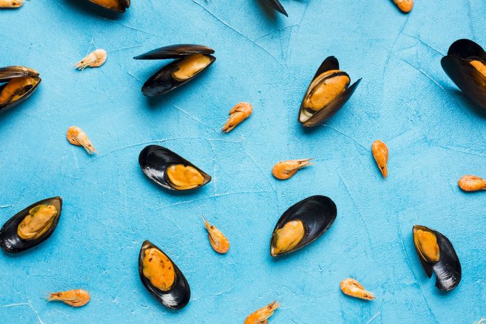 Flat-lay boiled mussels scattered on tabletop