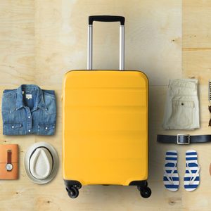 Travel concept with a large suitcase and other accessories