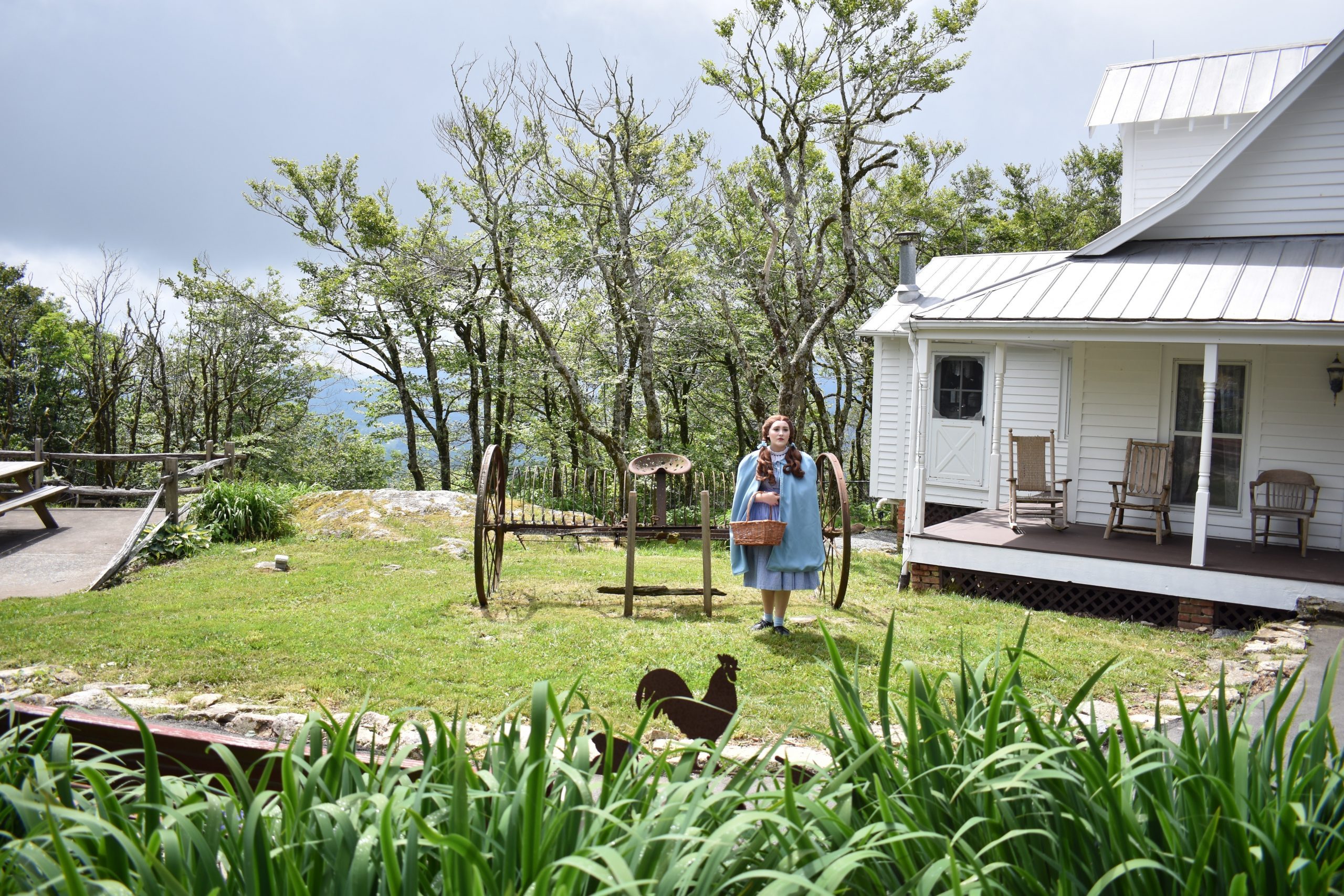 Beech Mountain, NC /USA/June 13, 2019/Land of Oz, Dorothy Standing in front of the Gale's family Farm House