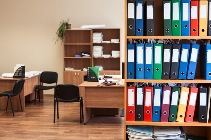 Corporate office room with storage of color folders as archive or repository, nobody