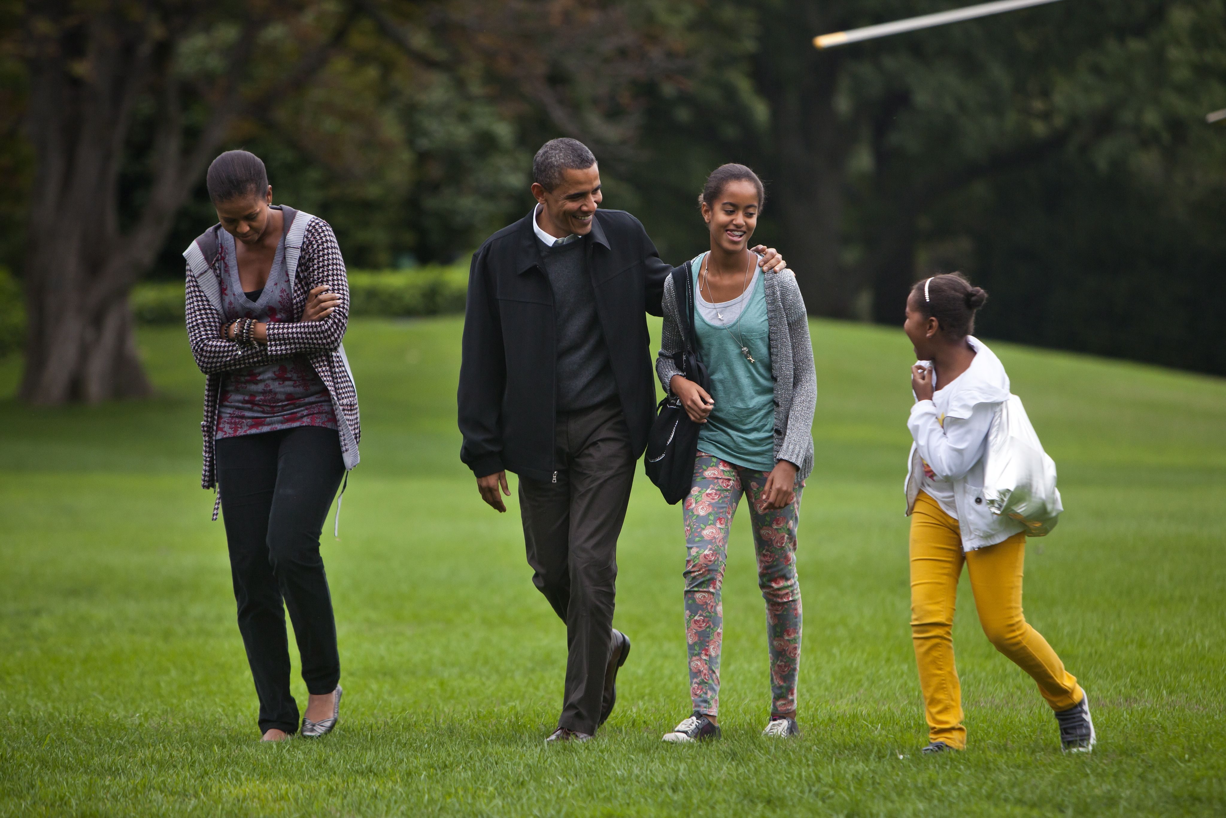 Mandatory Credit: Photo by Jim Lo Scalzo/EPA/Shutterstock (7624580b) U S President Barack Obama with His Wife Michelle and Daughters Malia (under His Arm) and Sasha Returns From Camp David Maryland to the White House in Washington Dc on 03 October 2010 the President's Week Ahead Includes a Meeting with the Economic Recovery Advisory Board As Well As the First Ever White House Summit on Community Colleges United States Washington Usa President Obama Returns White House - Oct 2010