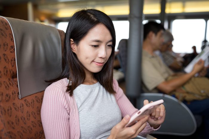 Woman using mobile phone on the ferry