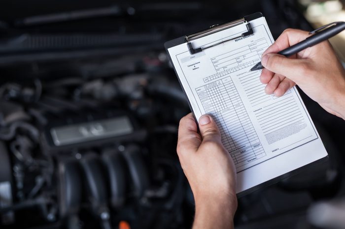 mechanic repairman inspecting car closeup