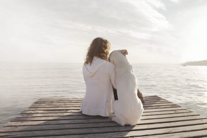 woman and her dog admire together the scenery 