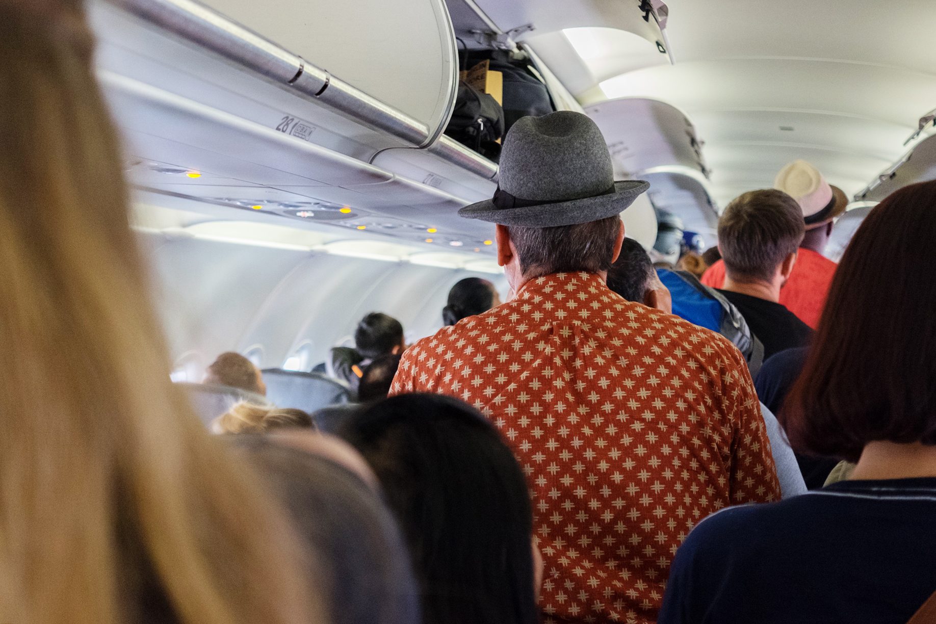 Passengers Disembarking Aircraft On Arrival, Back View