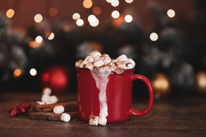 Red mugs with hot chocolate and marshmallows. Christmas concept