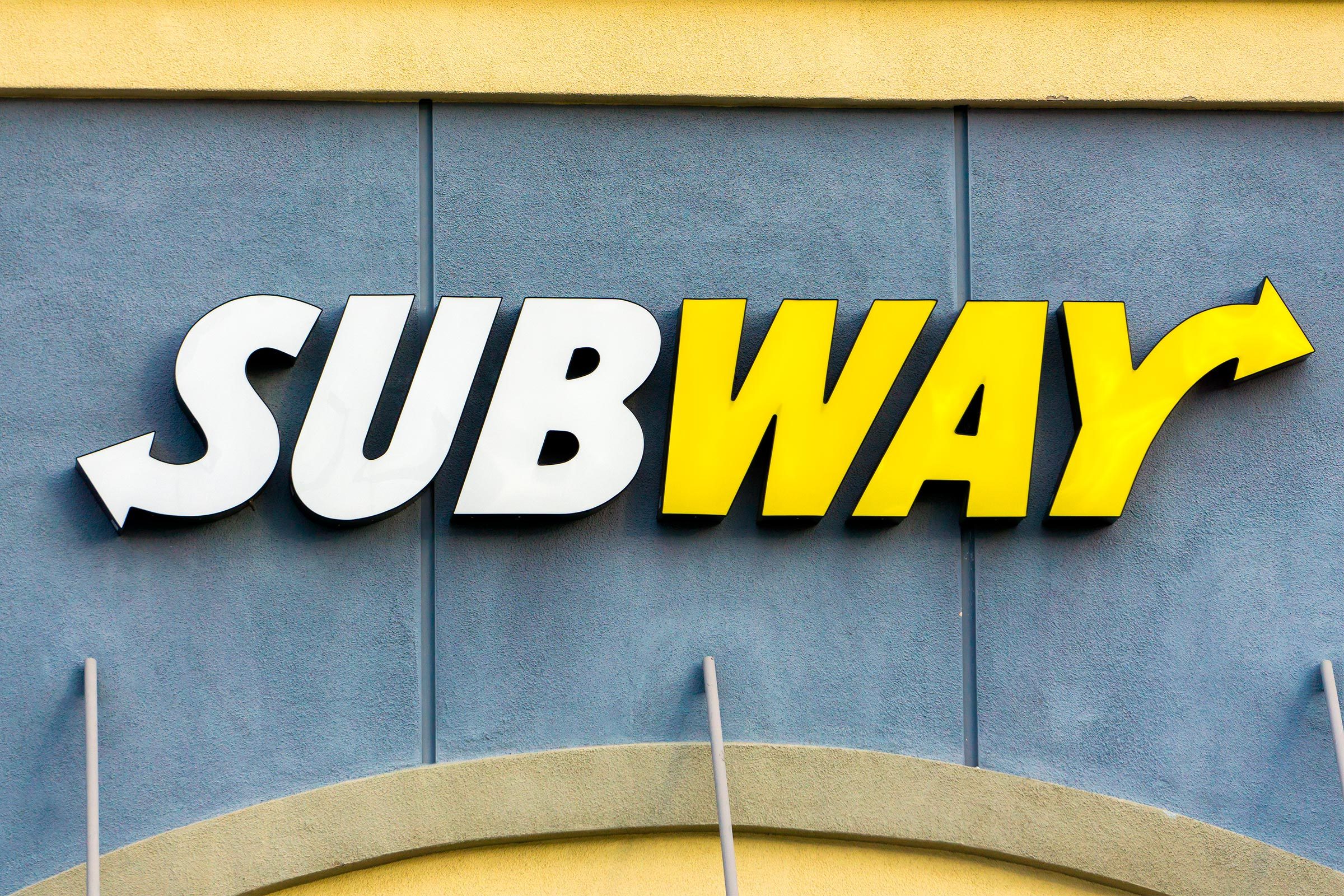 close up of exterior subway logo on a building facade