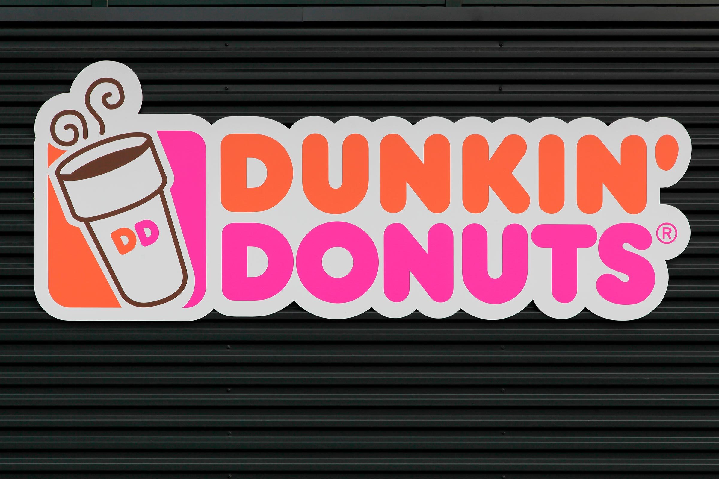 Dunkin' Donuts sign on a wall.