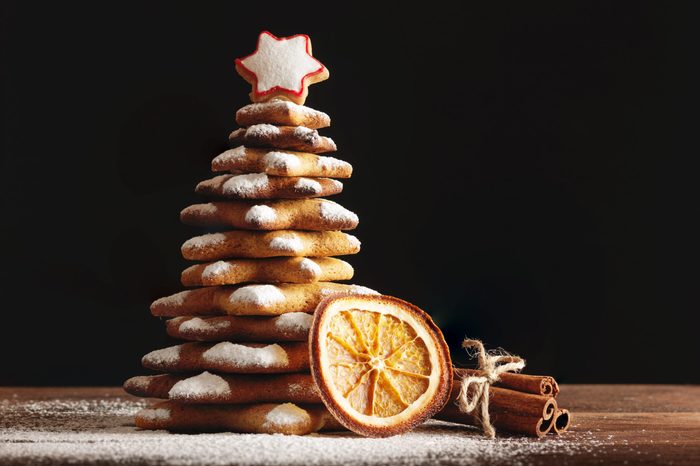 Baked gingerbread christmas tree on wooden background. Close-up