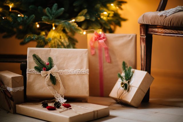 beautiful Christmas gifts under tree in new year decorated house interior