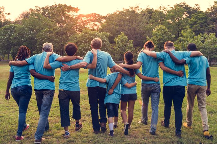 Group of diversity people volunteer arm around