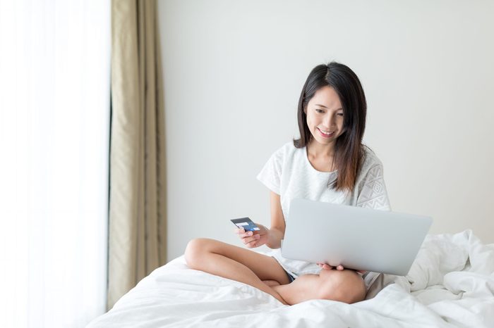 Woman shopping online with laptop computer and credit card