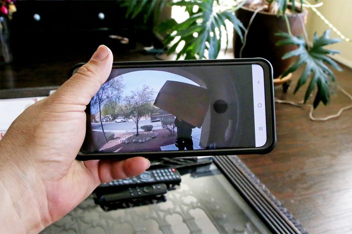Pov Watching Package Delivered Through Doorbell Camera