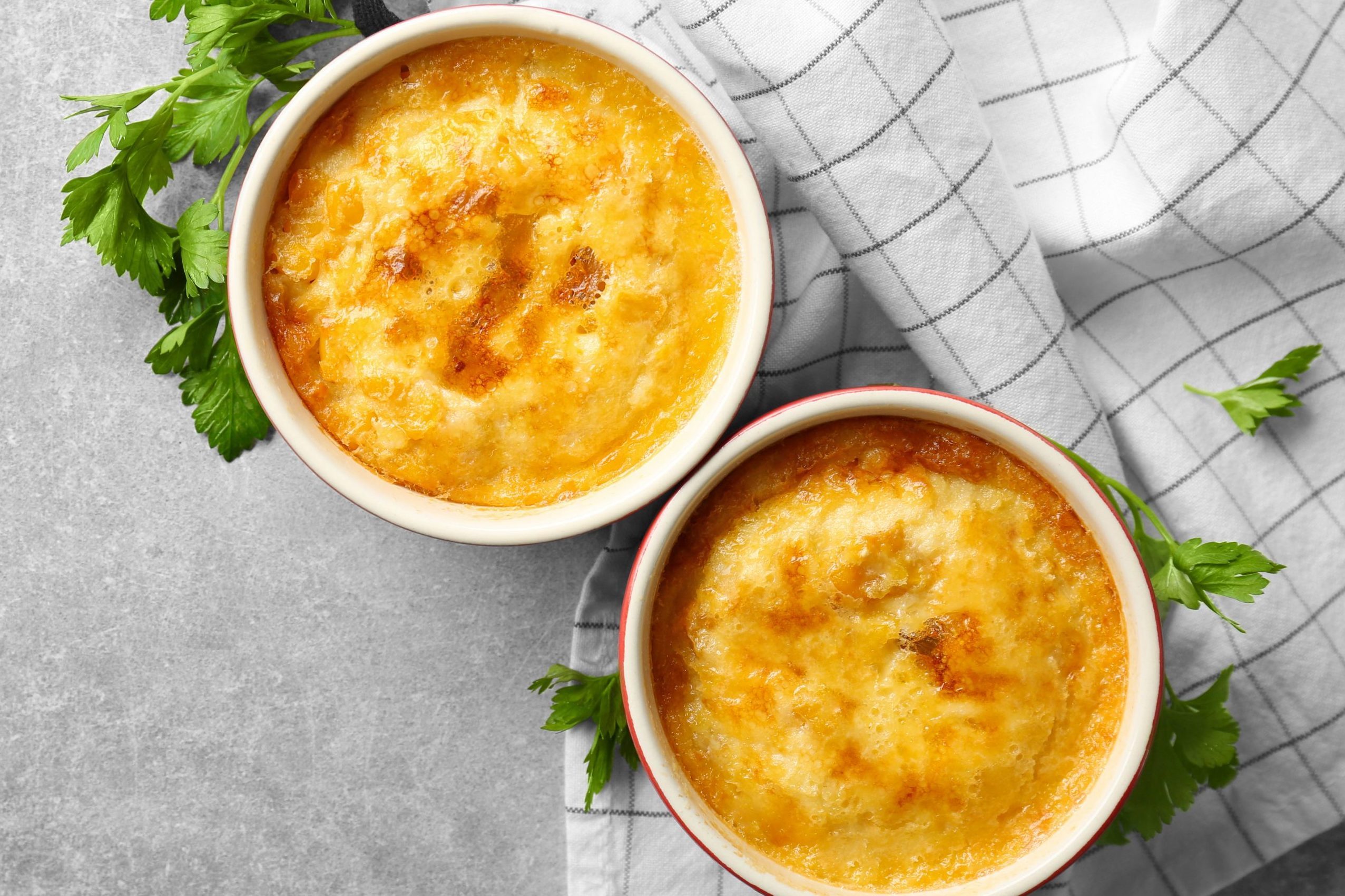 Ramekins with corn pudding on table