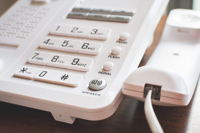 Off hook with work phone on wooden table