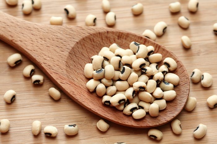 Black eyed peas in a wooden spoon. Close-up.