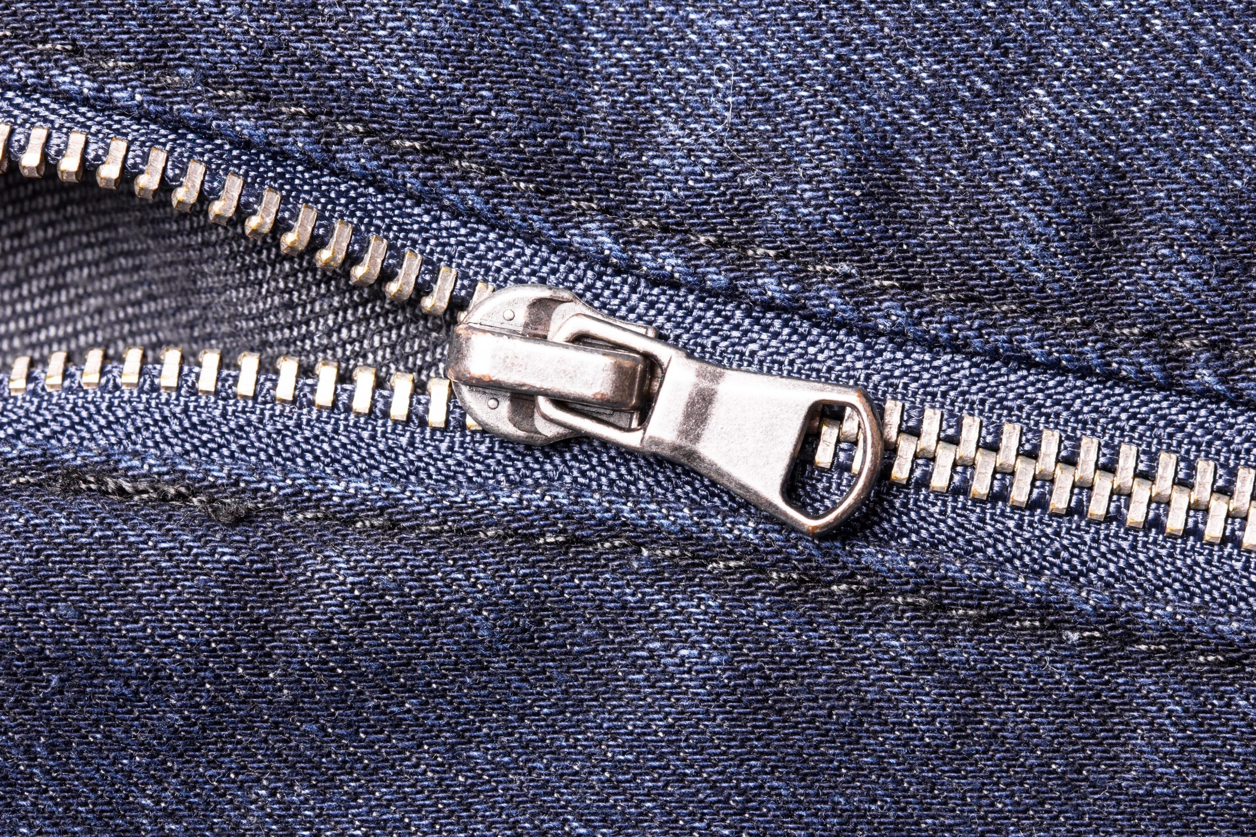 Blue jeans zipper closeup.