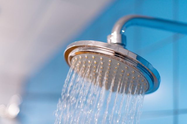 Shower head close up with water supply is turned on