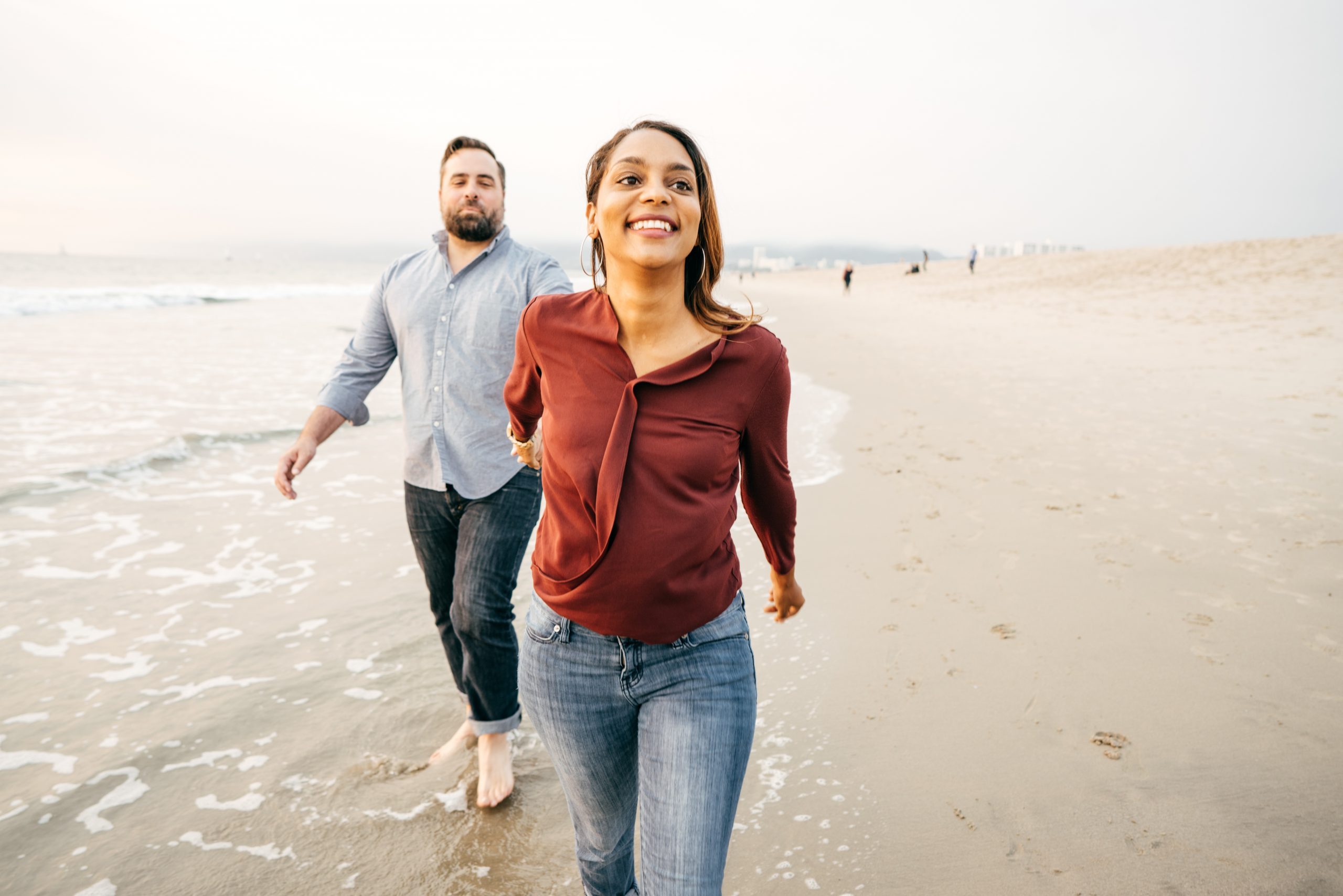 happy couple walking on the beach