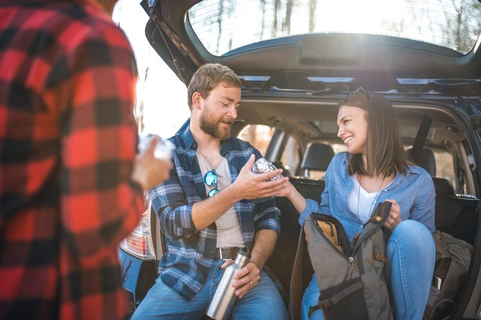 friends sharing food on a road trip