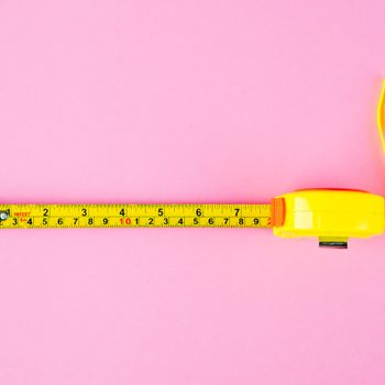 Measuring Tape on pink background