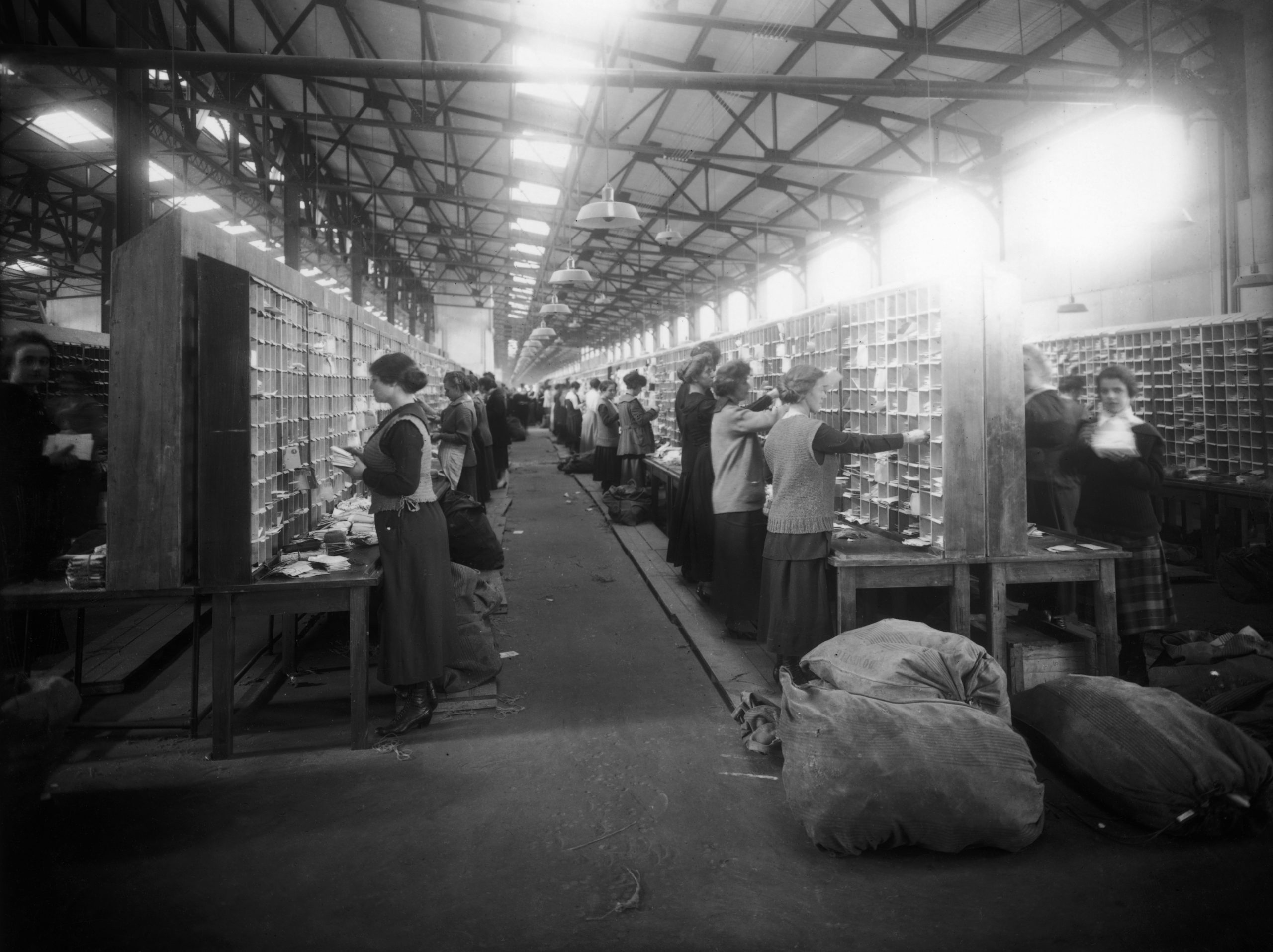 Women postal workers at a sorting office, circa 1920.