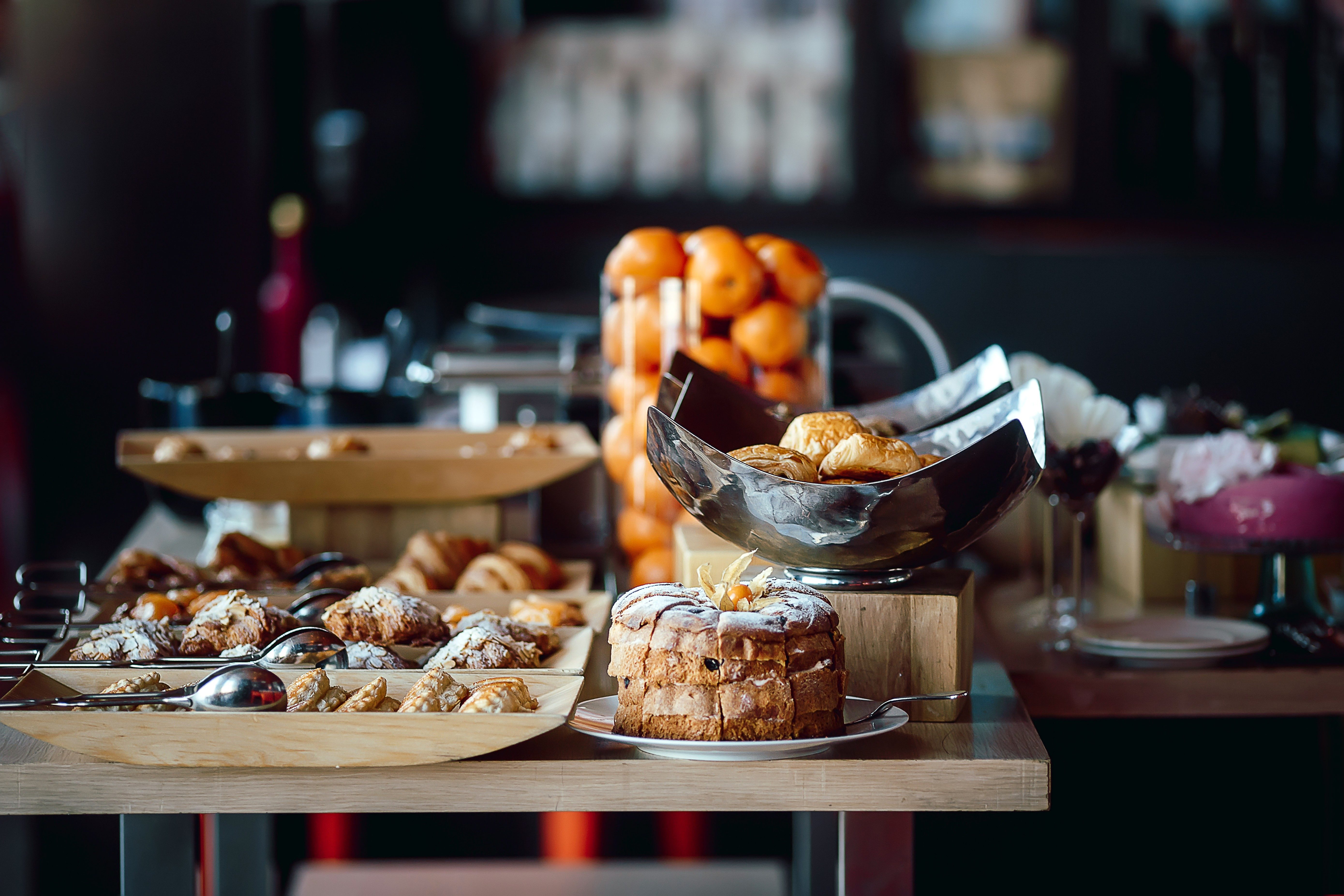 Assortment of fresh pastry and mandarin on table in buffet