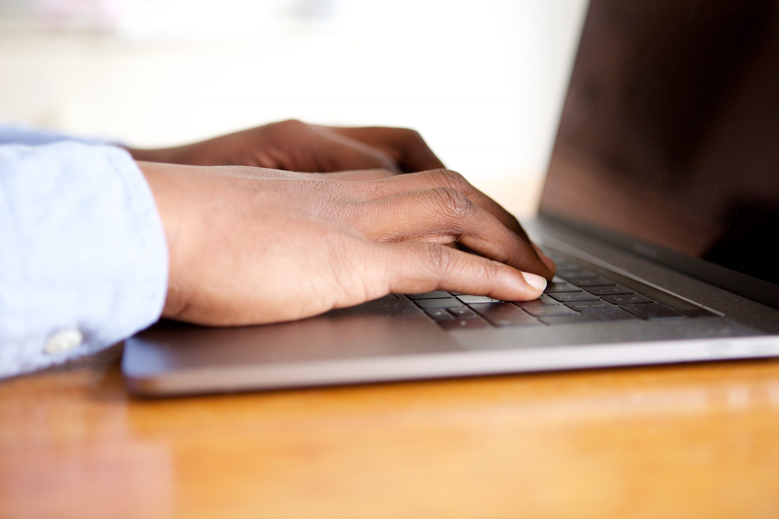 Close up male hands on keyboard of laptop