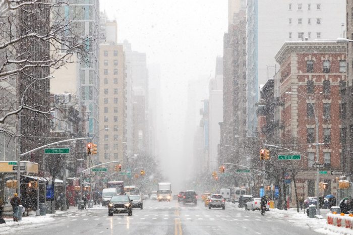 Snowy winter street scene looking down 3rd Avenue in the East Village of Manhattan during a nor’easter snowstorm in New York City