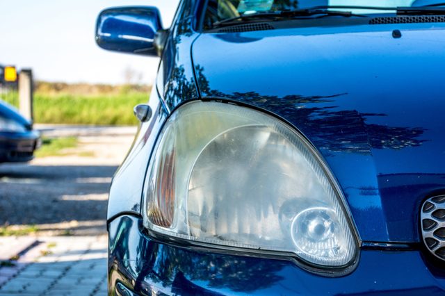 Front headlight unpolished cloudy foggy of old car