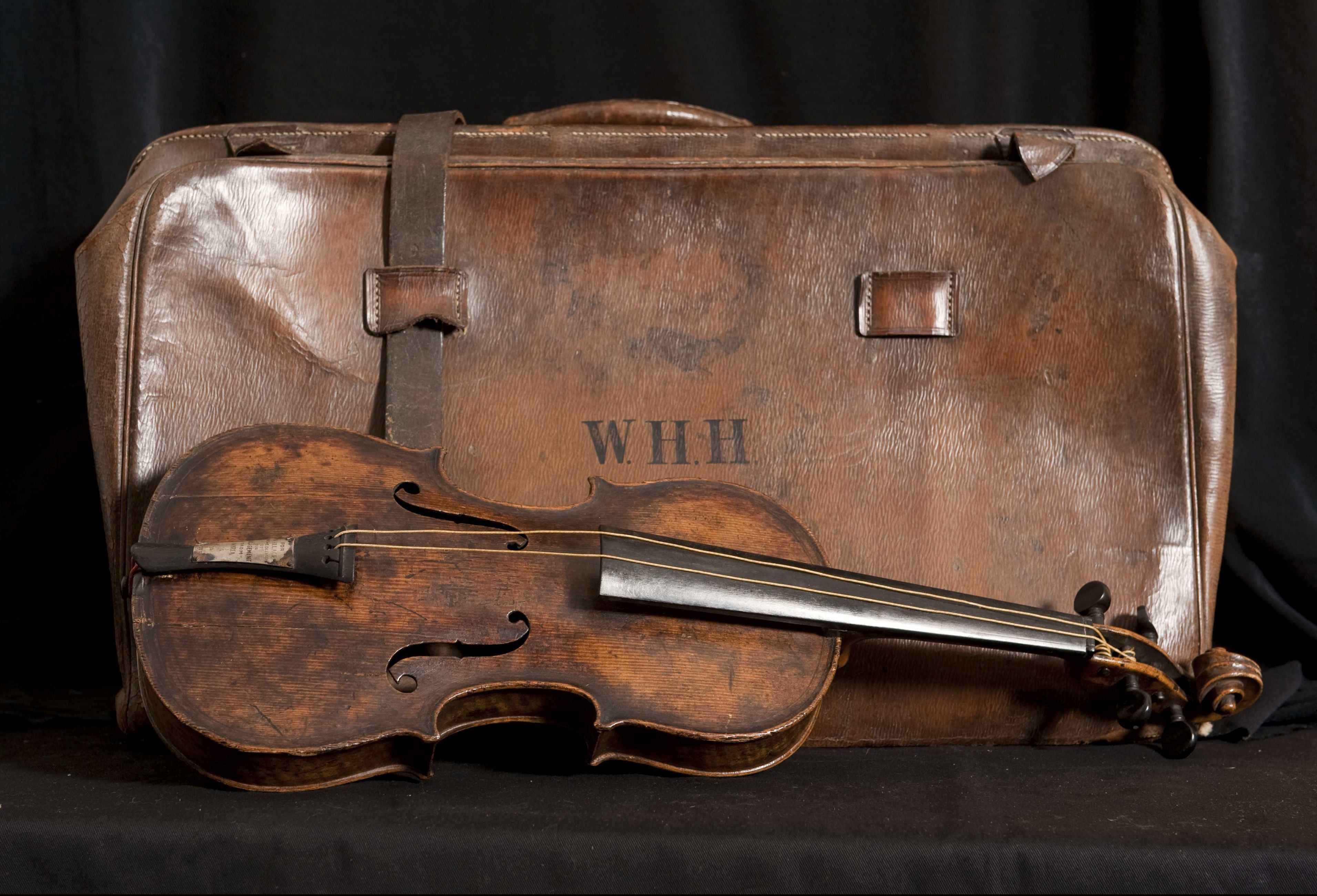 Mandatory Credit: Photo by Bournemouth News/Shutterstock (3245064f) The violin and its case Violin played as Titanic sank sells for £900,000, Wiltshire, Britain - 20 Oct 2013 The historic violin that was famously played as the Titanic sank has been sold at auction in Wiltshire for £900,000. The wooden instrument has been proven to be the one used by Wallace Hartley as his band famously played on to help keep the passengers calm during the disaster. Its existence and survival only emerged in 2006 when the son of an amateur violinist who was gifted it by her music teacher in the early 1940s contacted an auctioneers. It had taken seven years for the Devizes auction house, Henry Aldridge & Son, to authenticate the instrument. Several experts were used, including forensic scientists who said the wood still contained salt deposits from the sea water. It is said that the violin survived because it was in a leather case strapped to Mr Harley's body. The new owner of the instrument has remained anonymous but is believed to be British.