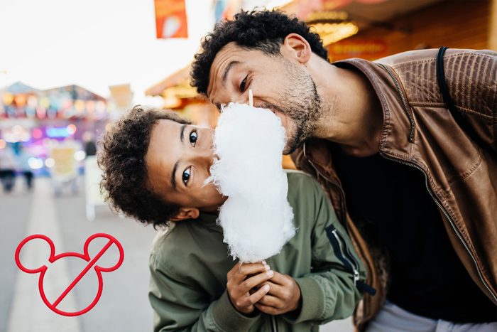 father and son eating cotton candy