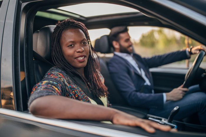 man and woman in a car. focus on passenger.