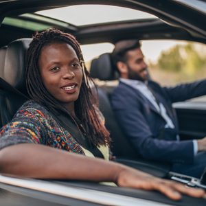 man and woman in a car. focus on passenger.