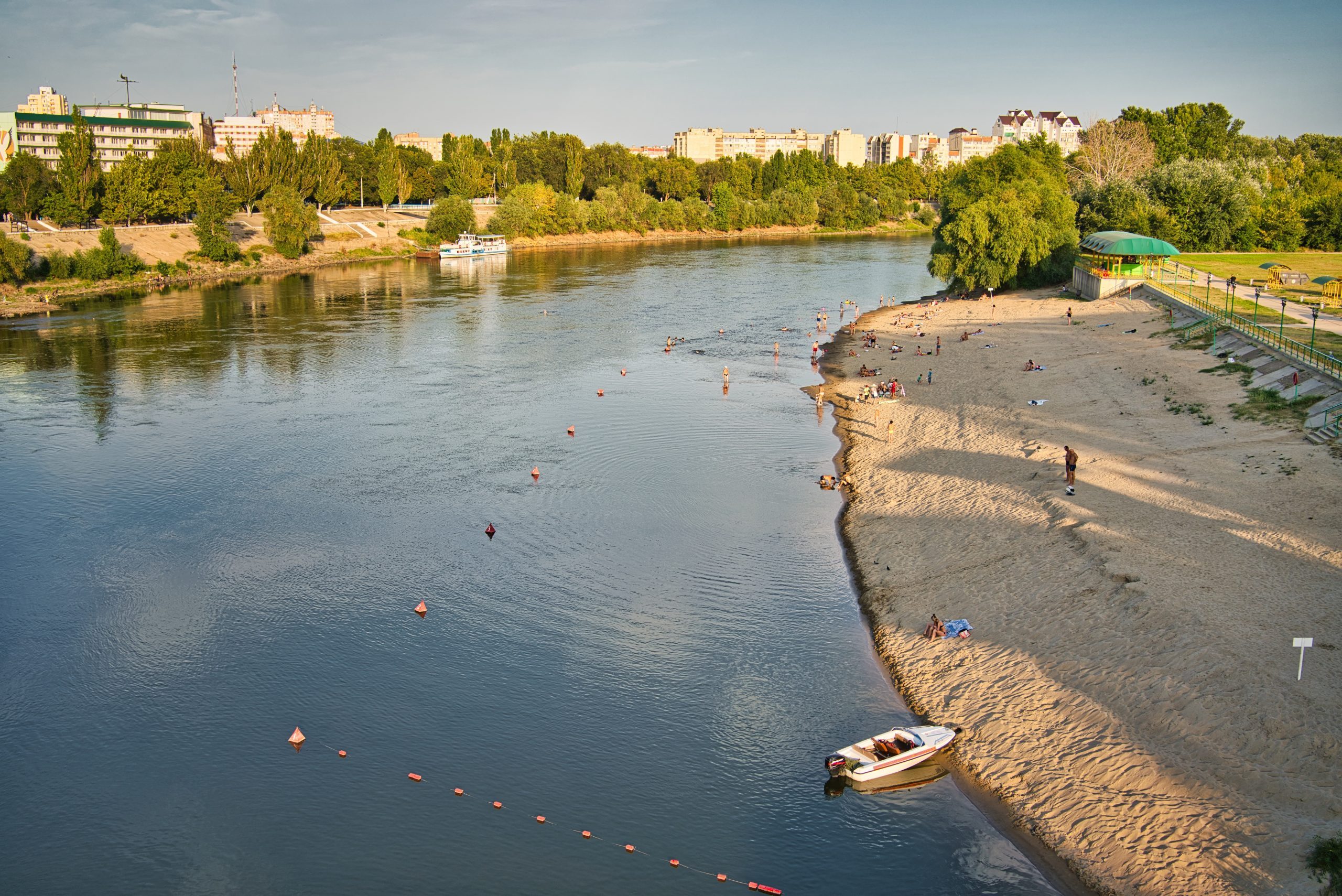 People sunbathing on the shore of Dniester River in Tiraspol, Transnistria