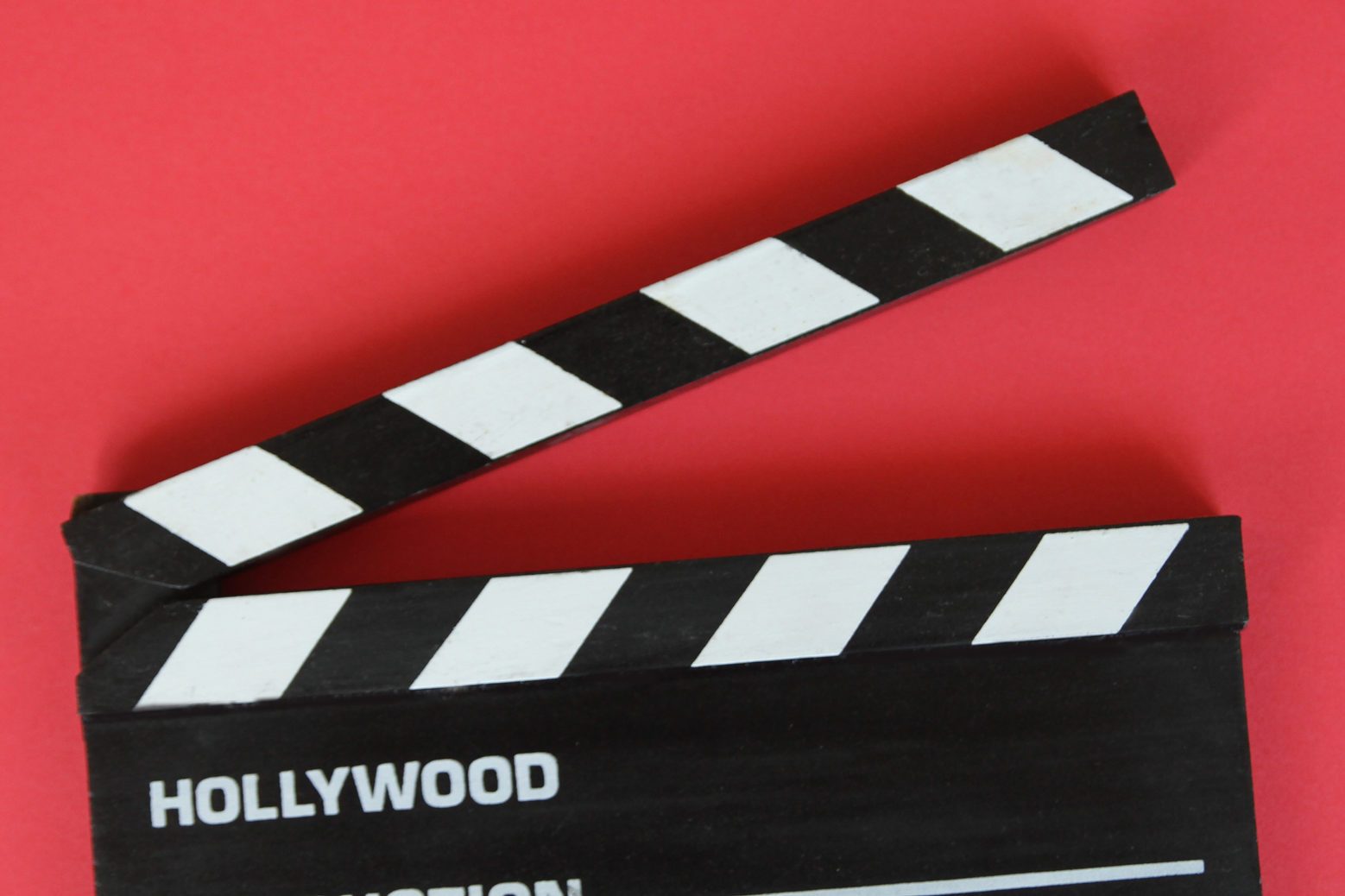 Filmmaker's Clapboard On Red Background.