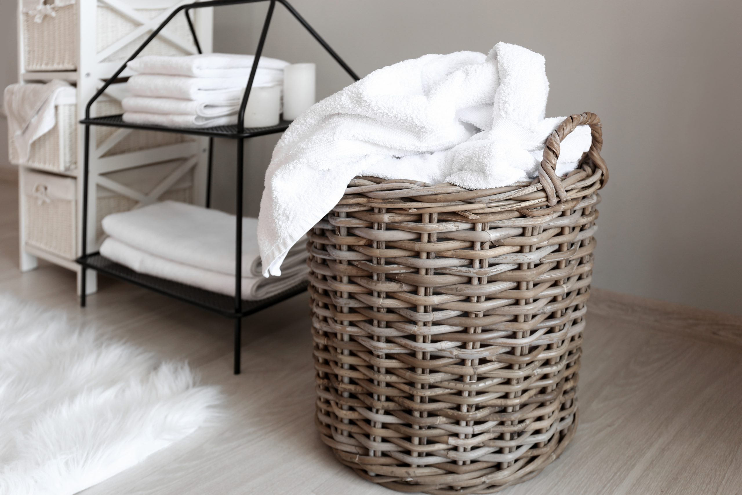 Laundry basket with dirty towels on floor