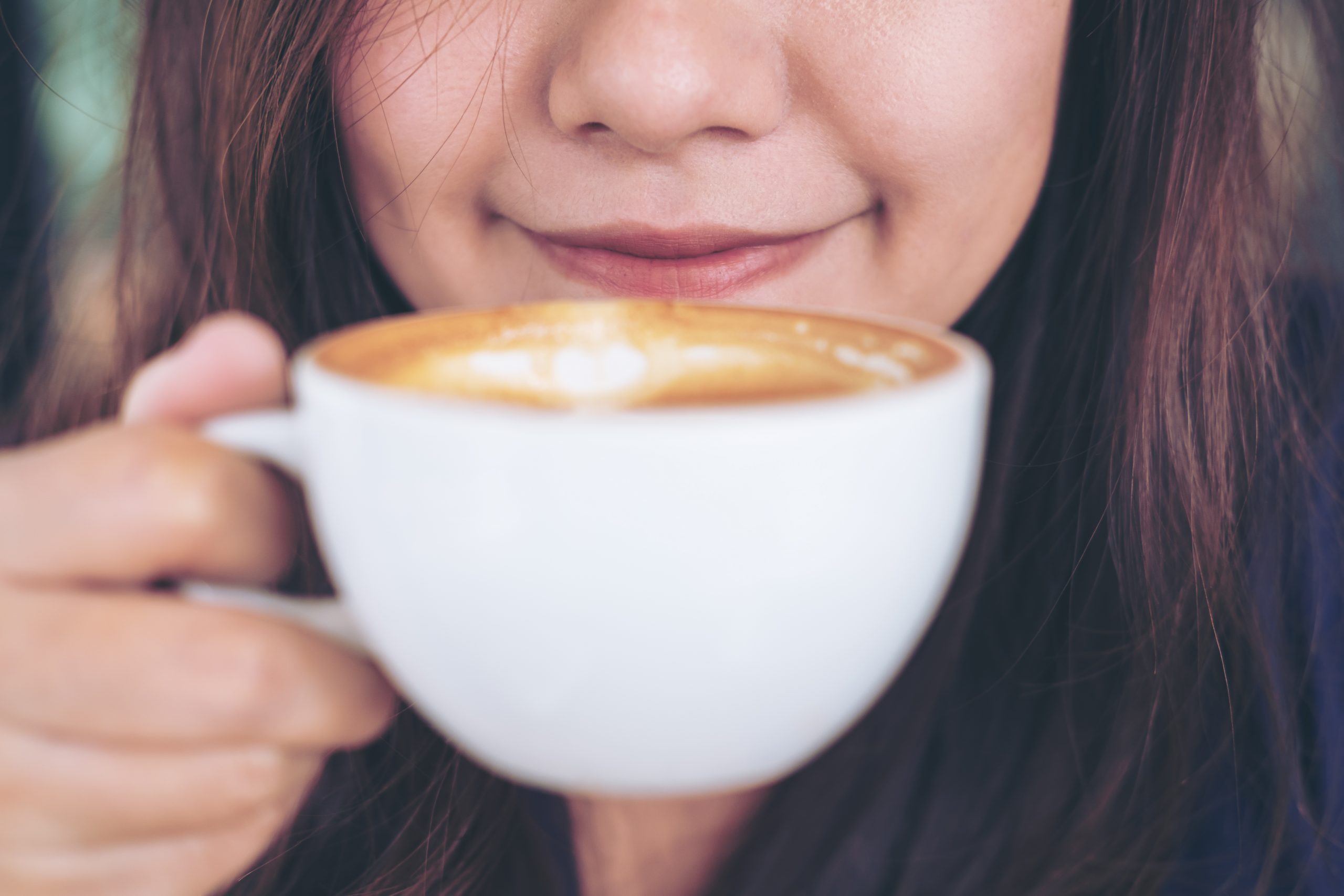 Midsection Of Woman Holding Coffee Cup