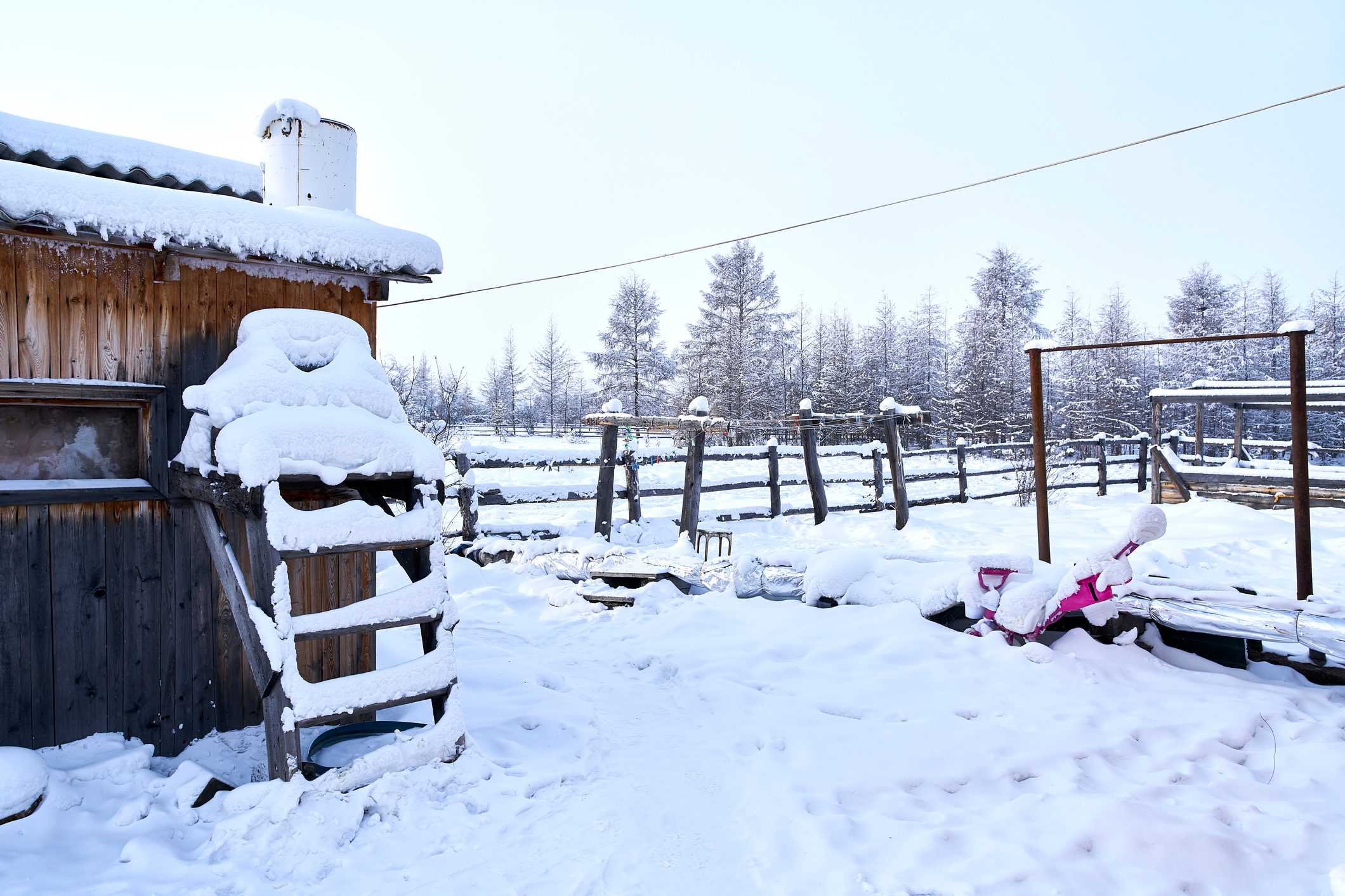 Typical Siberian houses in the village of Oymyakon (Pole of Cold), the coldest permanently inhabited place on earth, Sakha Republic, Russia