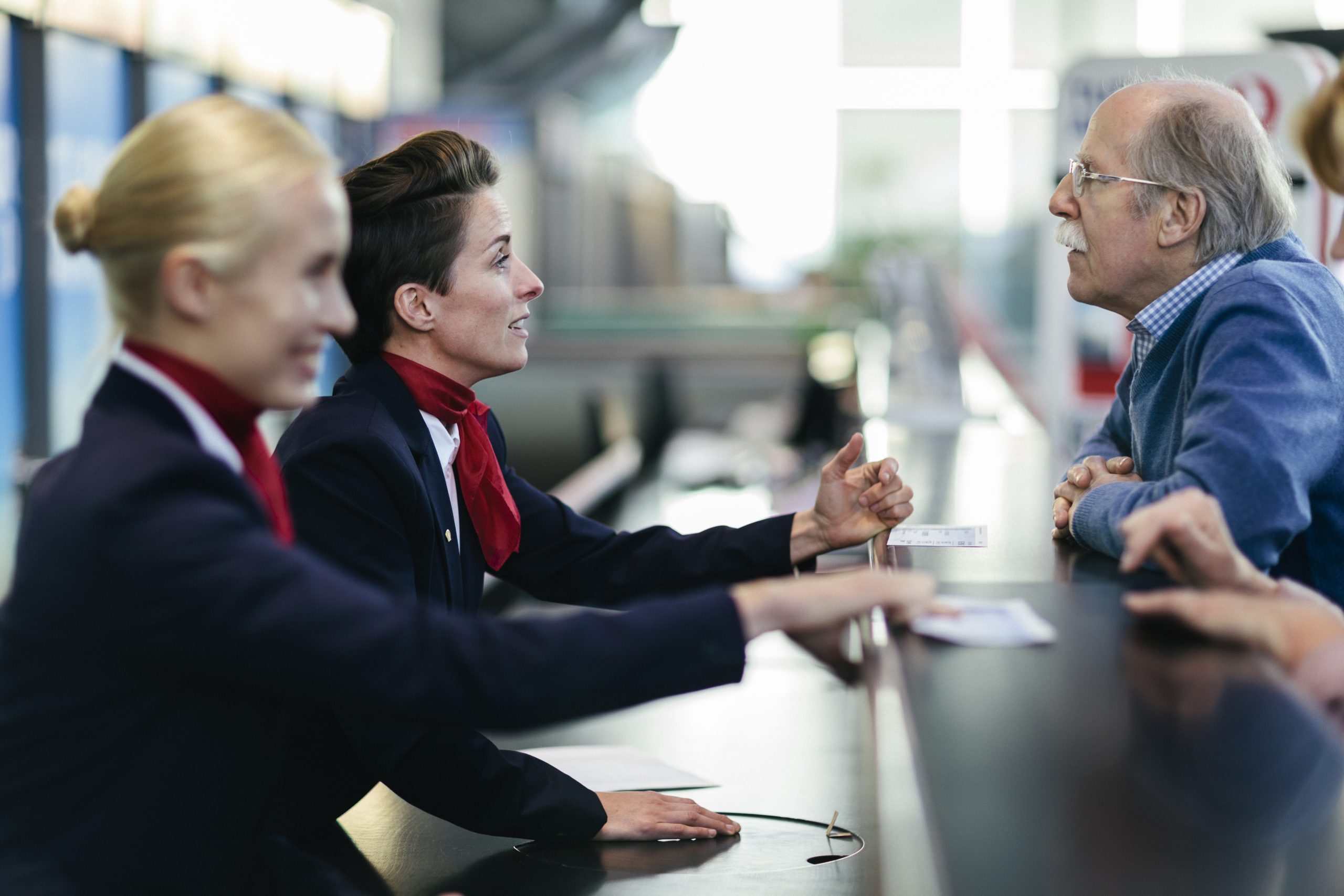 Senior Man At Airport Check-In Counter