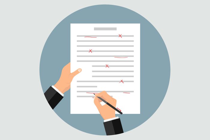 illustration of hands correcting grammar on a paper