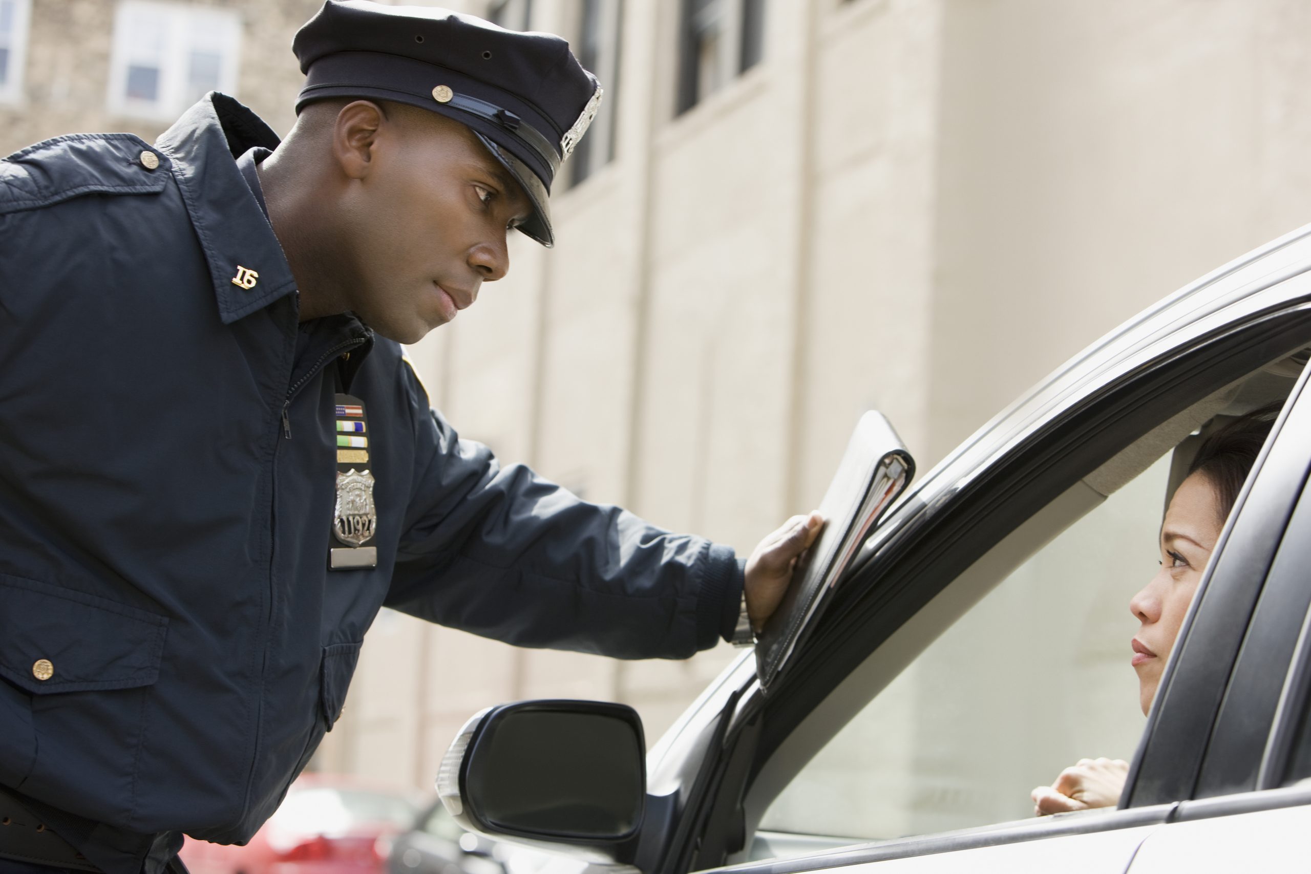 African policeman giving woman ticket