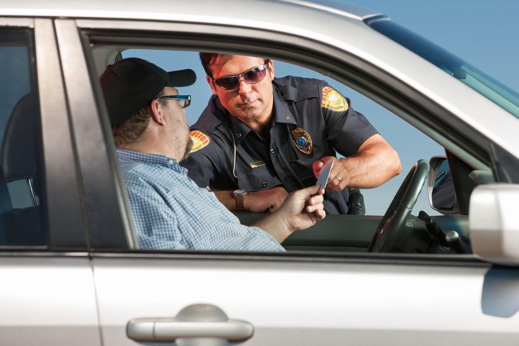 Motorist Handing Police Officer His License