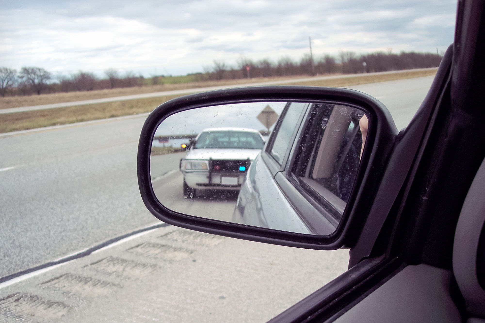 Police car in side mirror of car, Caught!